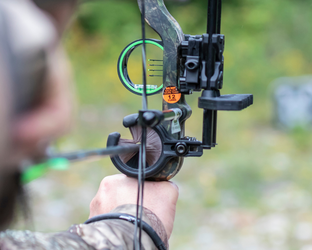Archery shooter with a compound bow